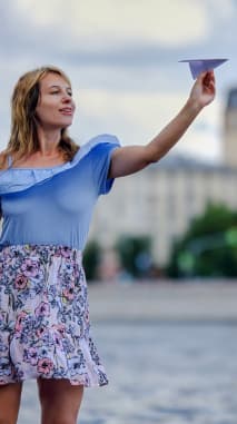 Mulher segurando um aviãozinho de papel